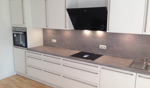 Renovated, quiet 2-room apartment with fitted kitchen, accessible features, garden access, terrace, and underground parking.