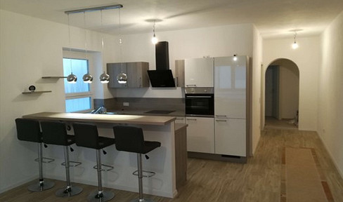 Exclusive 2-room ground-floor apartment with a kitchen island.
