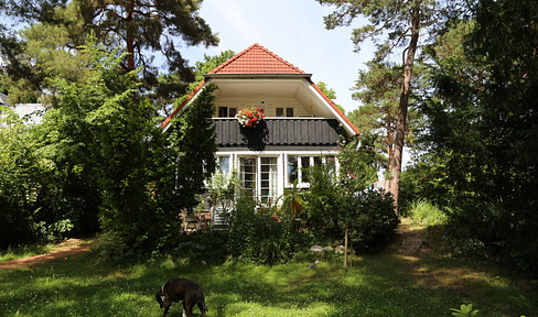 House in idyllic location with new building behind it