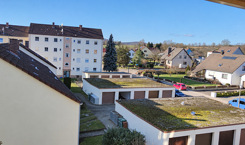 Bright apartment with a spacious living area, fitted kitchen, balcony, and private garage.