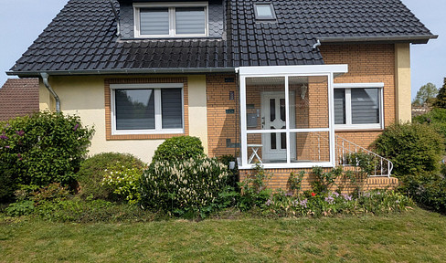 Two-family house with two garages and a large garden.