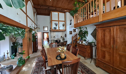 Historic farmhouse with a gallery, fireplace, and garden – stylishly renovated living space with character.
