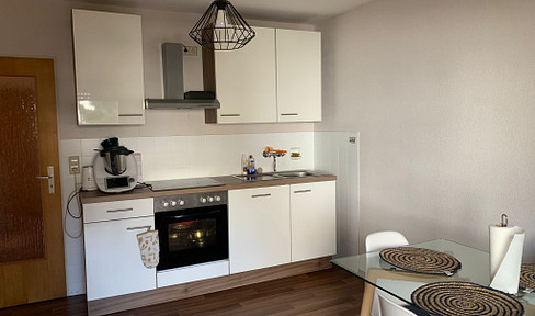 Charming 3-room apartment with fitted kitchen and balcony.