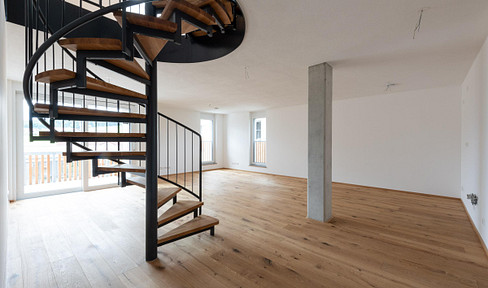 4-room maisonette apartment with a balcony offering views of the Grünten mountain, including one underground parking space.