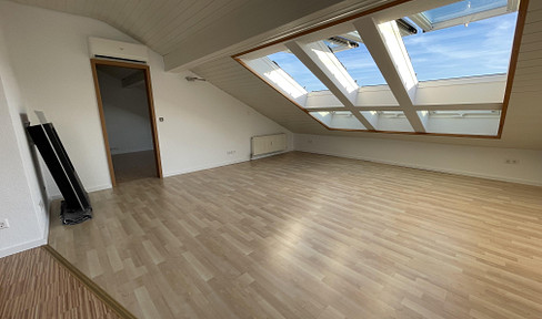 Bright, two-room attic apartment with fitted kitchen, built-in wardrobes, and air conditioning.