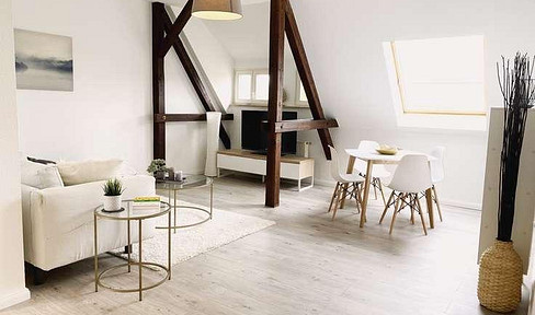 Bright 2-room attic apartment with a balcony and charming wooden beams.