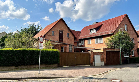 Residential house with workshop building, garage and garden