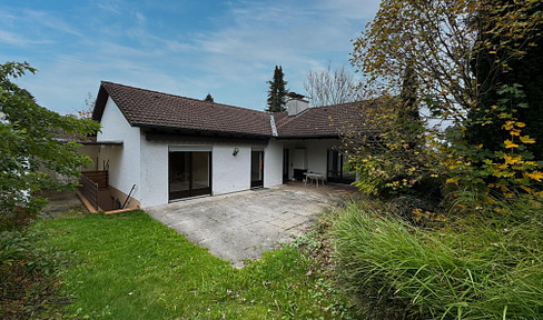 Bungalow surrounded by greenery with park-like garden and spacious plot