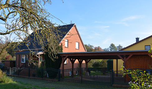 Two residential buildings with double carports and outbuildings