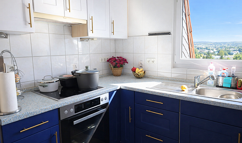 Furnished penthouse apartment with a kitchen, modern bathroom, and stunning views from a large balcony.