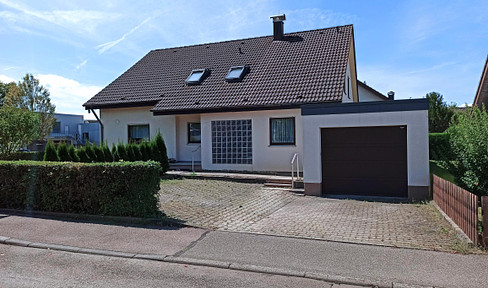 Two-family house with garage and parking spaces