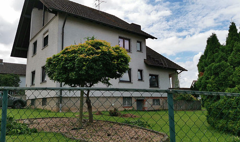 Private apartment building with large pond