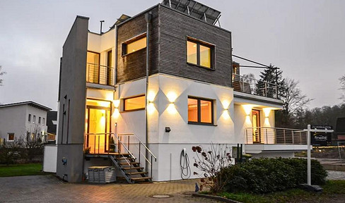 Modern Bauhaus-style villa with swimming pool and water views