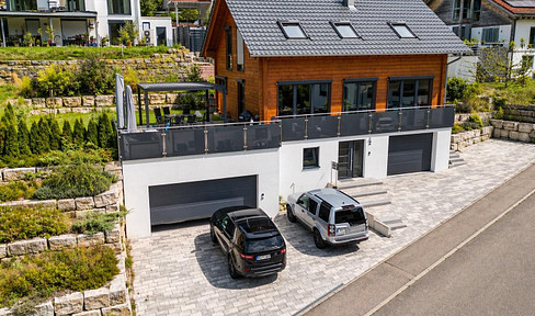 Modern solid wood house with stunning views, a garden, and a double garage.