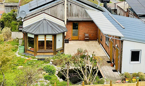 Sustainable bungalow with conservatory, garage and garden