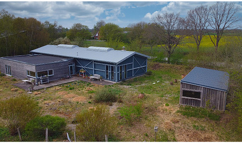 Modern multi-purpose hall with wooden extension on large, landscaped plot for sale from private owner