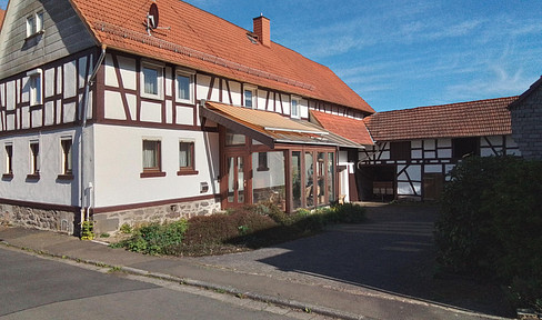 Half-timbered house with outbuilding, garden and fountain