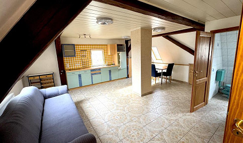 Half-timbering meets sandstone: A house with character and an attic that has been converted into living space.