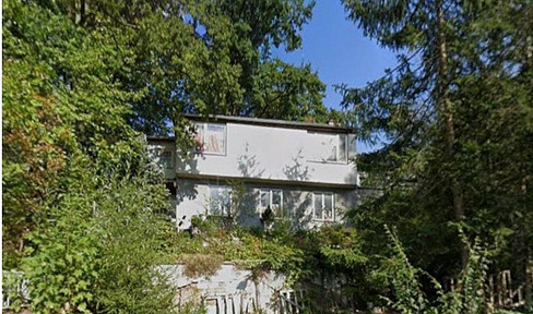 House in need of renovation in a sunny hillside location