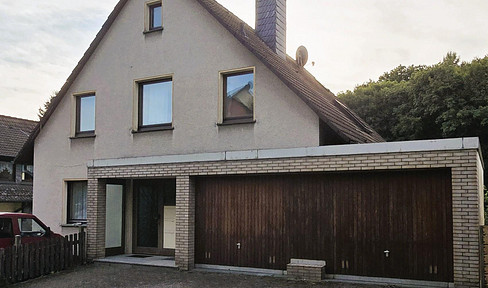 Commission-free: Partly let three-family house with direct forest location