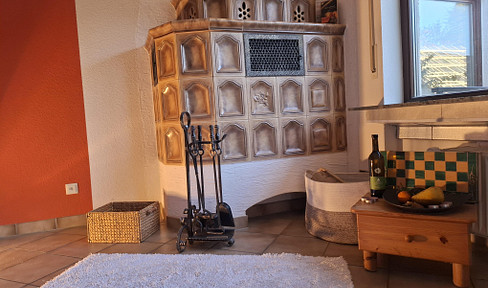 Light-flooded 3.5-room semi-detached house with tiled stove, garden & panoramic terrace