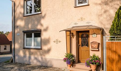 Welcome to your new home: A cozy house with a large barn, garden, and guest house.