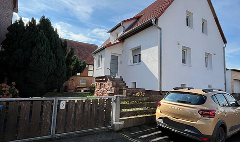Detached house with two separate residential units, barn and large plot of land
