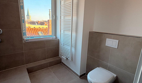 Top floor first-time occupancy: 4 rooms, top energy values & 10 m² balcony in a central location