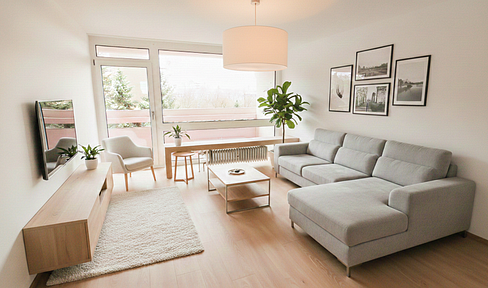 Prime location near the Olympic Park – 3-room apartment with a south-facing balcony and underground parking in Schwabing-West.