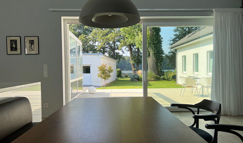 Well-maintained villa with private lake access, a pier, a guest house, and a sauna, located near Berlin, featuring designer furniture.
