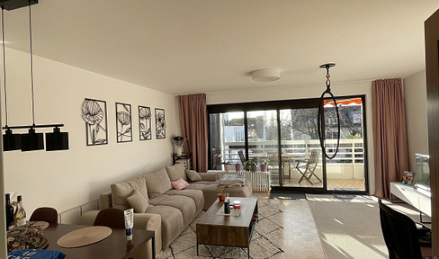 Opportunity near the Rhine: Bright apartment with 2 bedrooms, a kitchen, a sunny balcony, and a garden view.