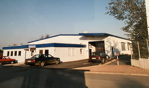 Versatile commercial hall, office building, ramp, and parking spaces.