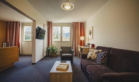 Serviced apartment with fitness center and swimming pool.