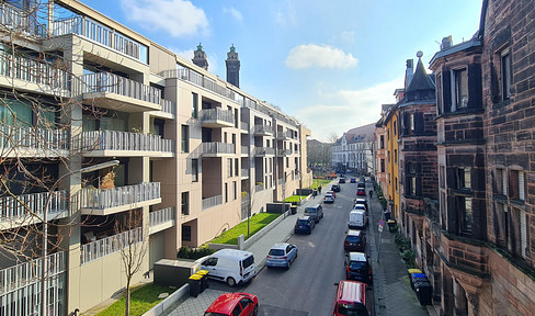 Parking space for a car in a new building, centrally located, with provision for a charging station and support for photovoltaic systems.