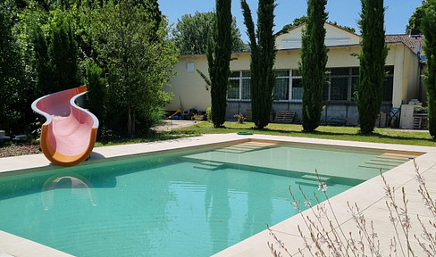 Luxury villa with a guest house, expansive park-like grounds, and development potential.