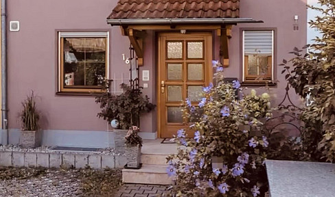 A terraced house with no garden maintenance fees, featuring a beautiful, well-established garden.