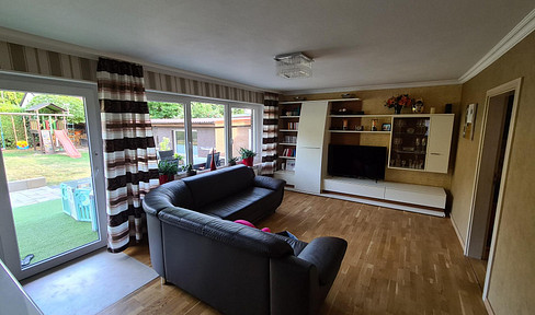 Ground-floor apartment with 5 rooms, a garden, outdoor kitchen, double garage, and parking space – living like you're in a house.