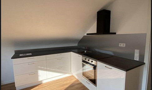 Renovated 2-room apartment with 89 square meters, fitted kitchen, guest toilet, and garage, located in Grabenstetten.
