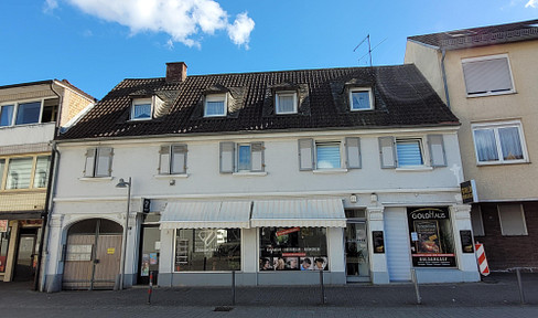 Fully occupied multi-family building (10 apartments and 2 commercial units) with development potential.