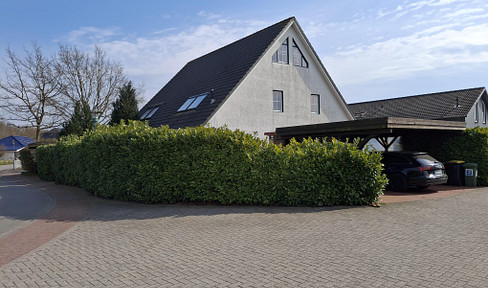 Near the Baltic Sea: Well-maintained semi-detached house with a fireplace, sauna, and double carport.