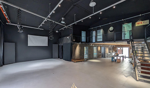 A loft-style space of 200 square meters with adjacent office areas, plus 100 square meters of office space on the upper floor.