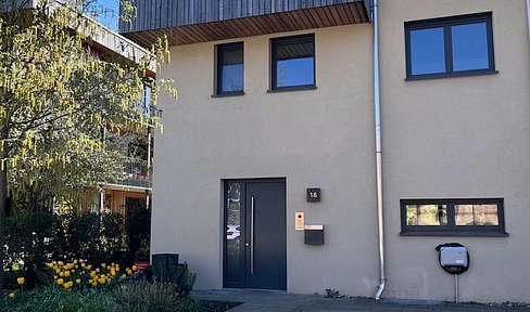 Modern and energy-efficient townhouse in the Ebenberg residential complex, featuring a rooftop terrace and garden.