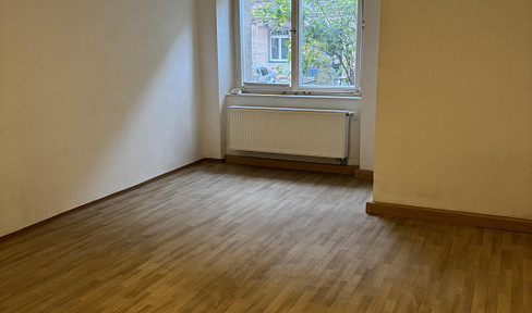 Spacious 1-bedroom apartment in a green setting.