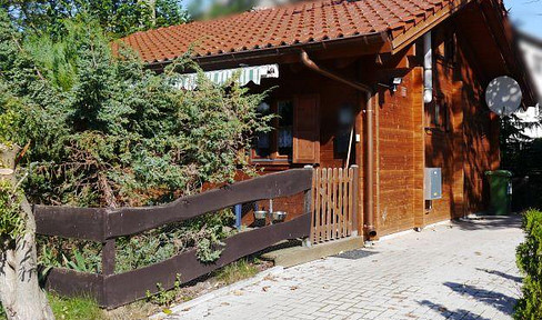 Log cabin-style vacation home for sale due to age, asking €139,000.