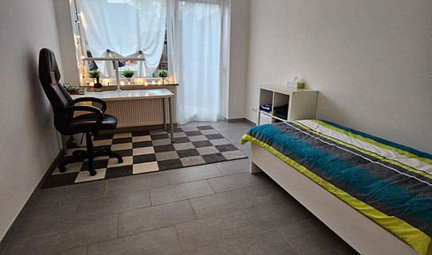 Room for rent in a shared apartment with three people, featuring a kitchen, two bathrooms, and a terrace.