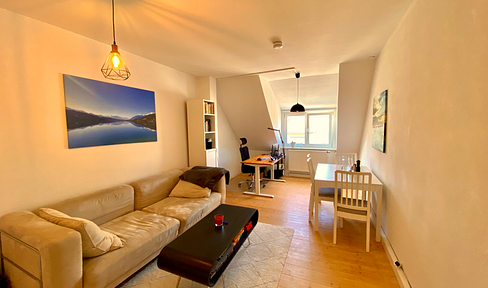 Subtenant wanted: Furnished 2-room attic apartment, directly on the Isar river, with a parking space in an underground garage.