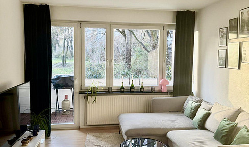 Spacious 2-room apartment with a kitchen and a balcony overlooking greenery.