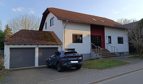Modern 1 or 2-family house with heat pump, solar panels, and climate control system.