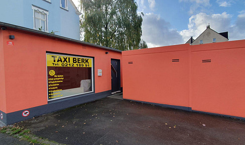 Commercial space with a storefront and small storage area.