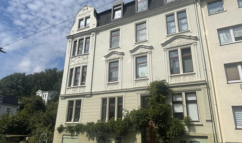Representative apartment with stucco details and a garden.